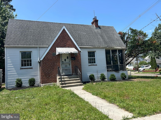 1903 Tinsman Ave, Pennsauken, NJ 08110 - view of front of house with a chimney, a front yard, entry steps, roof with shingles, and a sunroom