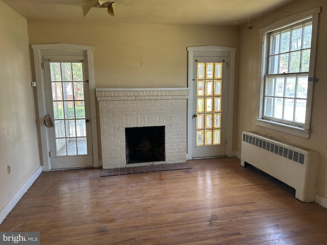 1903 Tinsman Ave, Pennsauken, NJ 08110 - unfurnished living room with radiator, ceiling fan, wood finished floors, and a fireplace