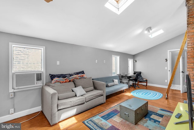 1243 Battery Ave, Baltimore, MD 21230 - living room featuring cooling unit, wood finished floors, a skylight, and vaulted ceiling