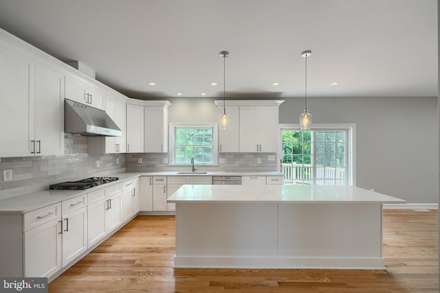 10905 Powers Ave, Cockeysville, MD 21030 - kitchen featuring under cabinet range hood, gas cooktop, light countertops, backsplash, and white cabinets