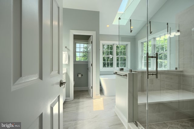 10905 Powers Ave, Cockeysville, MD 21030 - bathroom with a skylight, a soaking tub, a shower stall, marble finish floors, and lofted ceiling