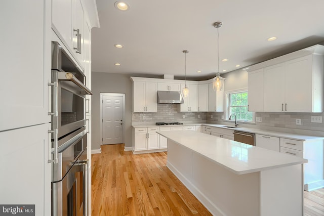 10905 Powers Ave, Cockeysville, MD 21030 - kitchen with stainless steel appliances, white cabinetry, tasteful backsplash, a center island, and recessed lighting