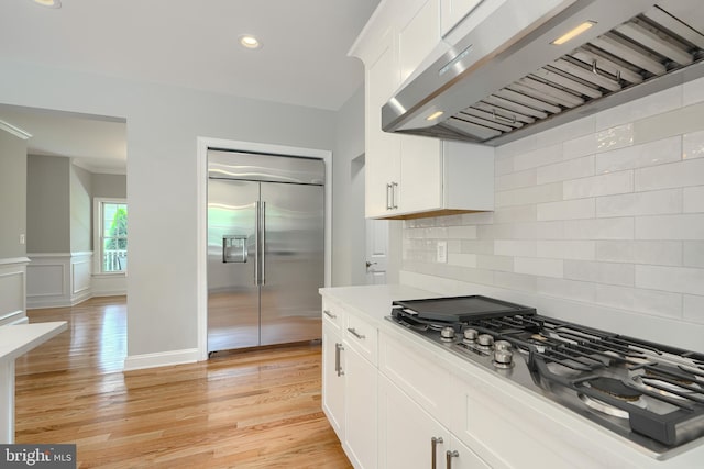 10905 Powers Ave, Cockeysville, MD 21030 - kitchen featuring stainless steel appliances, extractor fan, white cabinetry, tasteful backsplash, and recessed lighting
