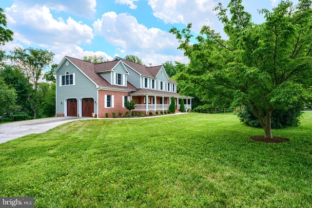 10905 Powers Ave, Cockeysville, MD 21030 - view of front of house with an attached garage, covered porch, concrete driveway, a front lawn, and brick siding