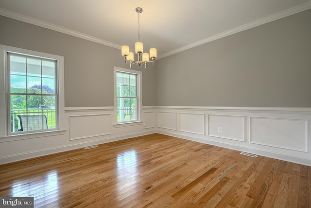 10905 Powers Ave, Cockeysville, MD 21030 - unfurnished room with a chandelier, crown molding, light wood finished floors, and a wainscoted wall