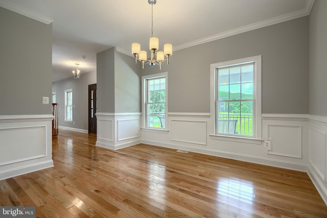 10905 Powers Ave, Cockeysville, MD 21030 - unfurnished dining area featuring a chandelier, plenty of natural light, light wood finished floors, wainscoting, and ornamental molding