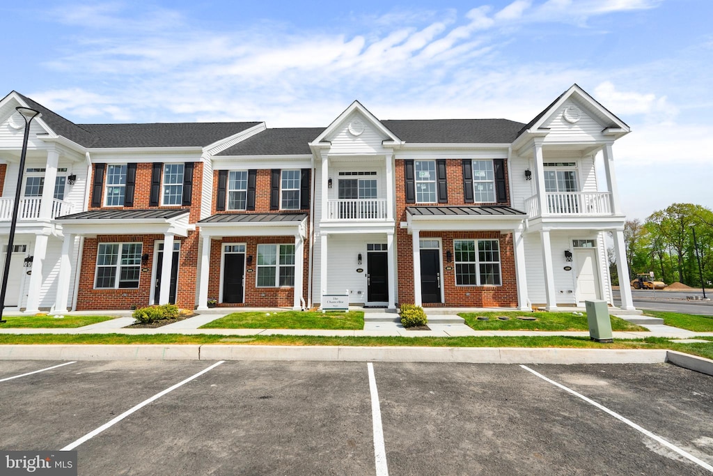 2 Ivy Ln Unit 95, Levittown, PA 19055 - townhome / multi-family property featuring brick siding, a balcony, and uncovered parking