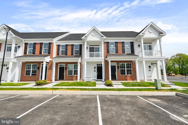 2 Ivy Ln Unit 95, Levittown, PA 19055 - townhome / multi-family property featuring brick siding, a balcony, and uncovered parking