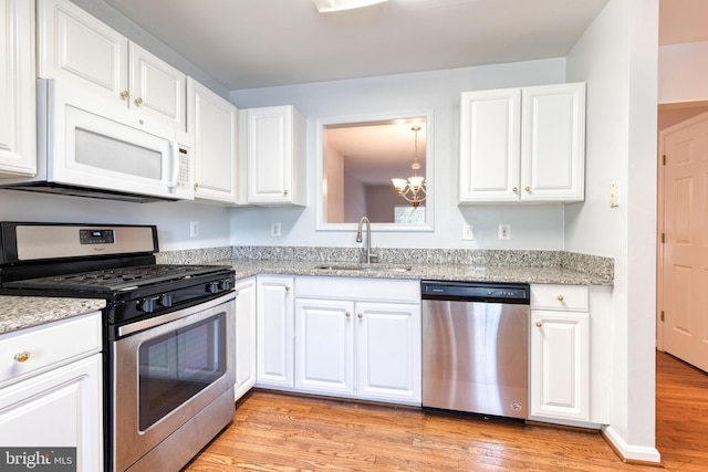 577 Francis Nicholson Way, Annapolis, MD 21401 - kitchen with appliances with stainless steel finishes, a chandelier, light wood-type flooring, white cabinets, and light stone counters