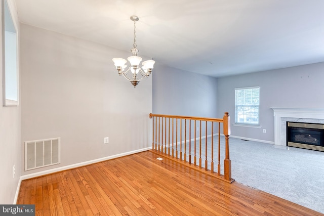 577 Francis Nicholson Way, Annapolis, MD 21401 - empty room featuring a chandelier, wood finished floors, and a high end fireplace