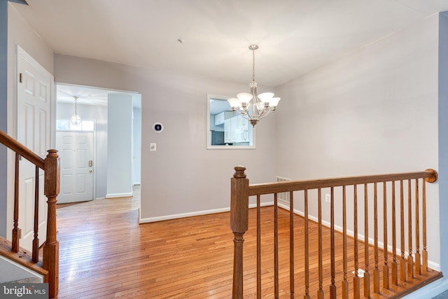 577 Francis Nicholson Way, Annapolis, MD 21401 - corridor featuring light wood-type flooring and a chandelier