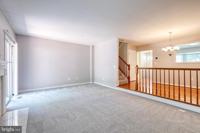 577 Francis Nicholson Way, Annapolis, MD 21401 - unfurnished living room with carpet flooring, a chandelier, and stairs