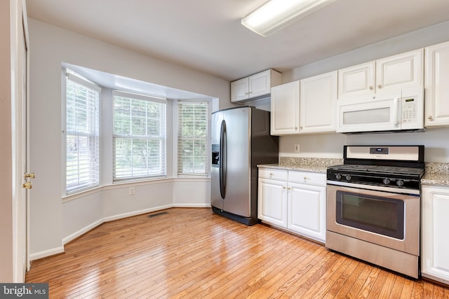 577 Francis Nicholson Way, Annapolis, MD 21401 - kitchen with appliances with stainless steel finishes, light wood finished floors, and white cabinetry