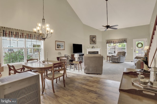 1283 Yarmouth Ln, New Cumberland, PA 17070 - dining space featuring ceiling fan, high vaulted ceiling, a fireplace, a chandelier, and wood finished floors