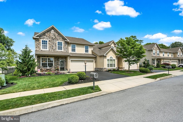 1283 Yarmouth Ln, New Cumberland, PA 17070 - view of front of home with stone siding, stucco siding, a garage, driveway, and a front lawn