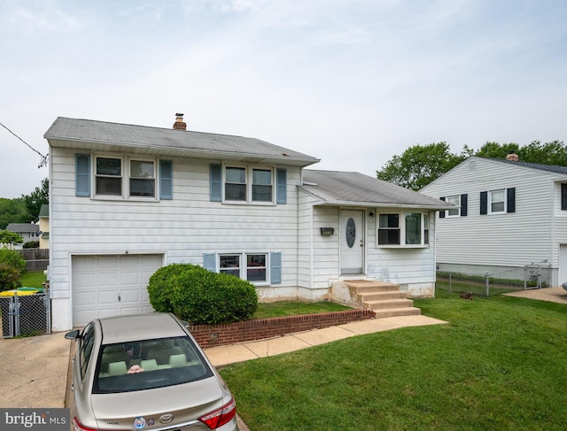 1319 Kenwood Rd, Wilmington, DE 19805 - tri-level home featuring a garage, a chimney, and driveway