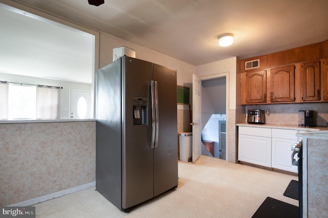1319 Kenwood Rd, Wilmington, DE 19805 - kitchen featuring stainless steel fridge with ice dispenser, light flooring, light countertops, brown cabinets, and white cabinetry