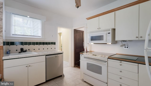 1081 Wynnwood Rd, Abington, PA 19001 - kitchen featuring white appliances, tile countertops, white cabinetry, decorative backsplash, and light tile patterned floors