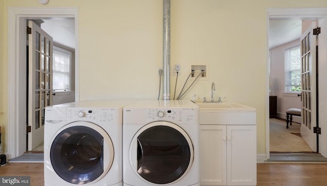 1081 Wynnwood Rd, Abington, PA 19001 - laundry area featuring washer and clothes dryer, light wood-style floors, and cabinet space