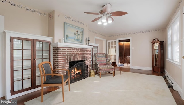 1081 Wynnwood Rd, Abington, PA 19001 - living area with a baseboard radiator, ceiling fan, french doors, a fireplace, and wood finished floors