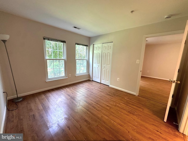 18815 Sparkling Water Dr Unit 4-O, Germantown, MD 20874 - unfurnished bedroom with wood finished floors and a closet