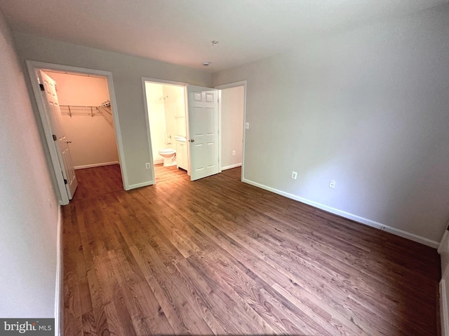 18815 Sparkling Water Dr Unit 4-O, Germantown, MD 20874 - unfurnished bedroom with a walk in closet, wood finished floors, a closet, and connected bathroom