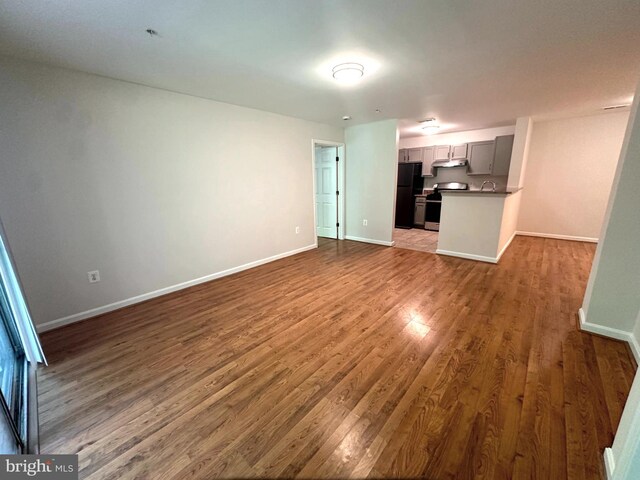 18815 Sparkling Water Dr Unit 4-O, Germantown, MD 20874 - unfurnished living room with dark wood-style flooring and baseboards