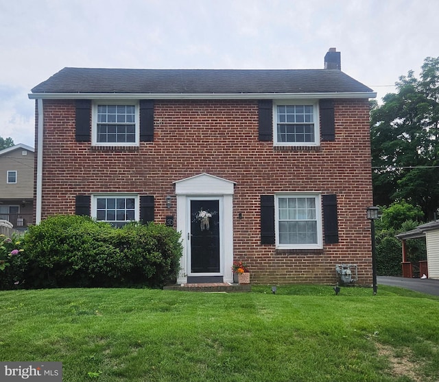 30 Wayne Ave, Springfield, PA 19064 - colonial home featuring a chimney, a front lawn, and brick siding