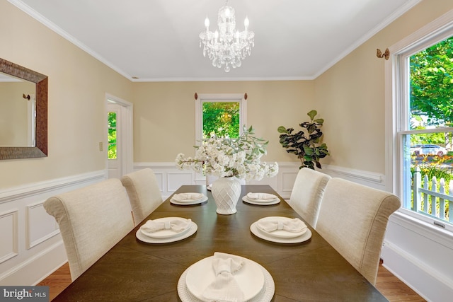1012 Grant St, Herndon, VA 20170 - dining space with healthy amount of natural light, ornamental molding, a chandelier, wood finished floors, and a wainscoted wall