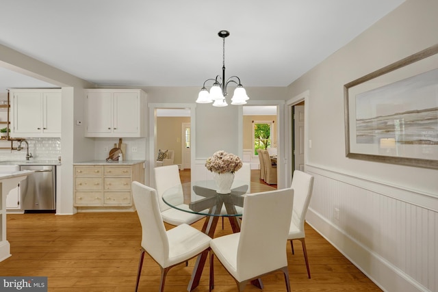 1012 Grant St, Herndon, VA 20170 - dining space featuring a wainscoted wall, a chandelier, and light wood-style floors