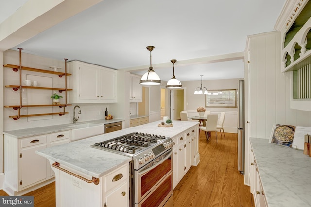 1012 Grant St, Herndon, VA 20170 - kitchen featuring appliances with stainless steel finishes, open shelves, light wood-type flooring, and a center island