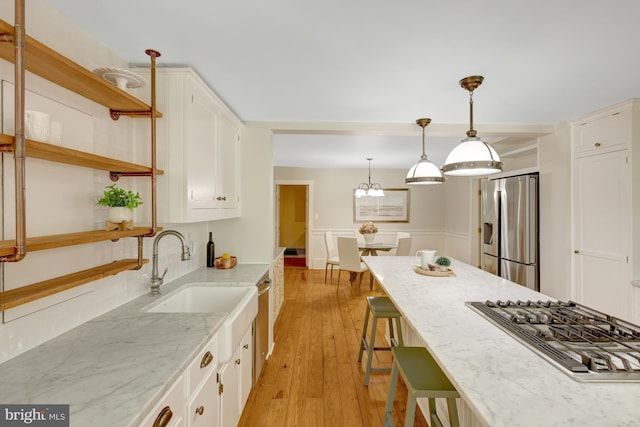 1012 Grant St, Herndon, VA 20170 - kitchen with stainless steel appliances, open shelves, white cabinets, light wood finished floors, and light stone counters