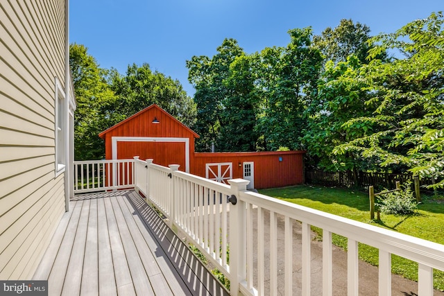 1012 Grant St, Herndon, VA 20170 - wooden deck featuring an outdoor structure, a detached garage, and view of wooded area