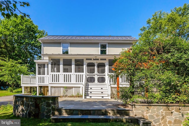 1012 Grant St, Herndon, VA 20170 - view of front of property featuring a standing seam roof, a sunroom, a metal roof, a deck, and stairs