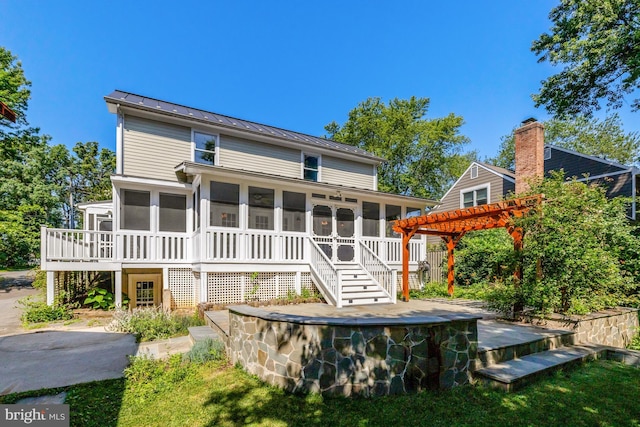1012 Grant St, Herndon, VA 20170 - back of property featuring a sunroom, a standing seam roof, a wooden deck, and a metal roof