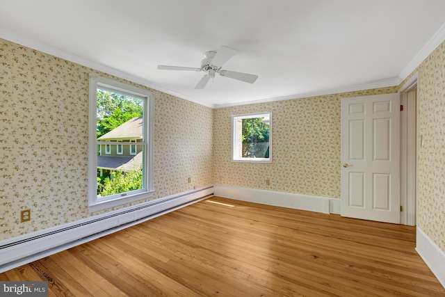 1012 Grant St, Herndon, VA 20170 - spare room with crown molding, a baseboard heating unit, light wood-style floors, wallpapered walls, and ceiling fan