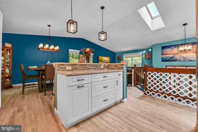 47 Sheridan Rd, Arnold, MD 21012 - kitchen with a chandelier, light wood finished floors, lofted ceiling, and a skylight