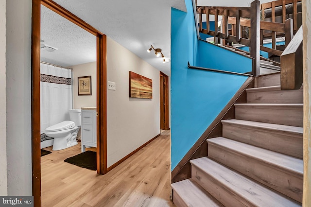 47 Sheridan Rd, Arnold, MD 21012 - stairs with wood finished floors and a textured ceiling