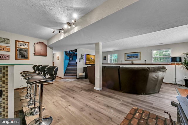 47 Sheridan Rd, Arnold, MD 21012 - living room with a textured ceiling, light wood-style floors, and stairs