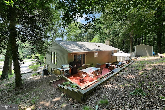 47 Sheridan Rd, Arnold, MD 21012 - rear view of property with a deck, a chimney, a storage unit, and outdoor dining space