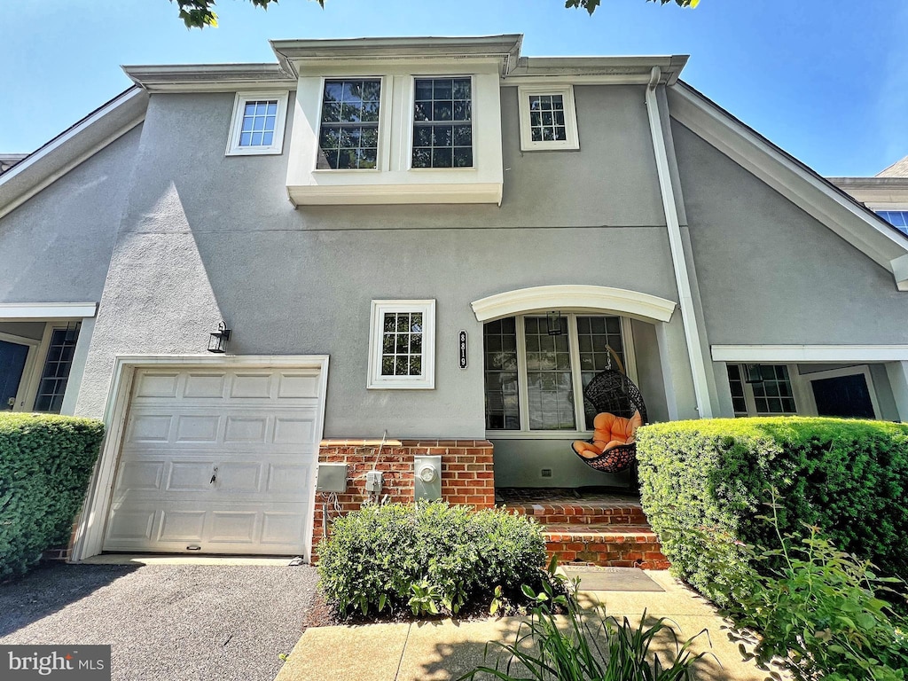 8819 Howard Frst Unit 8819, Baltimore, MD 21208 - view of front of home with stucco siding and a garage