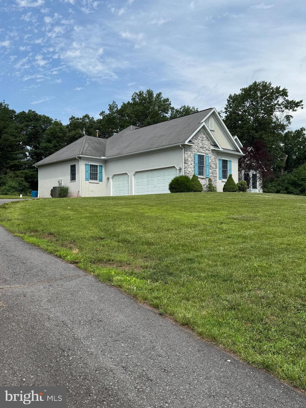 2219 Morgantown Rd, Reading, PA 19607 - ranch-style house with stone siding, a front yard, a garage, and stucco siding