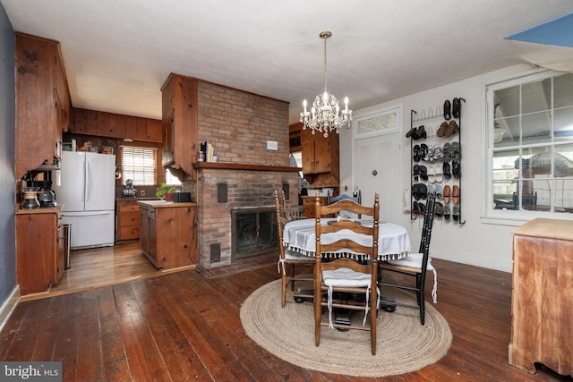 5378 Main St, Stephens City, VA 22655 - dining room with hardwood / wood-style flooring, a chandelier, and a brick fireplace