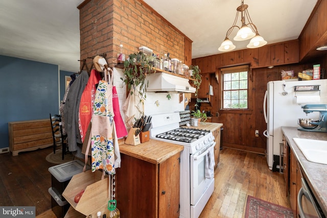 5378 Main St, Stephens City, VA 22655 - kitchen with white appliances, light wood-type flooring, premium range hood, wood walls, and light countertops