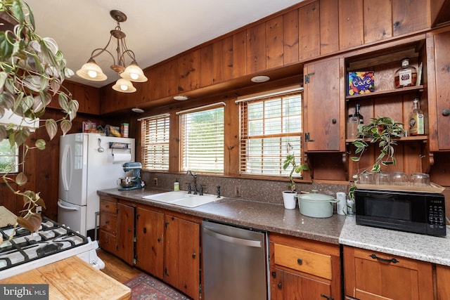 5378 Main St, Stephens City, VA 22655 - kitchen with white appliances, open shelves, brown cabinetry, a chandelier, and pendant lighting