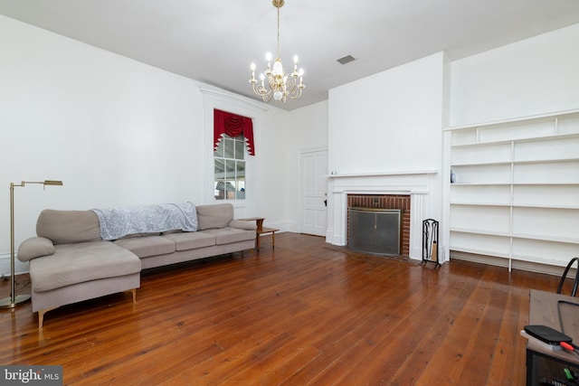 5378 Main St, Stephens City, VA 22655 - living area featuring a chandelier, wood-type flooring, and a brick fireplace