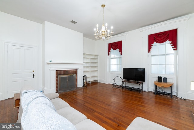 5378 Main St, Stephens City, VA 22655 - living room featuring a chandelier, wood finished floors, and a brick fireplace
