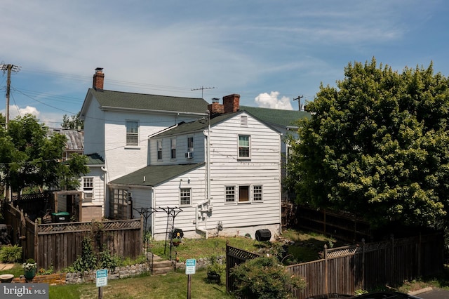 5378 Main St, Stephens City, VA 22655 - back of house with a chimney and a fenced backyard