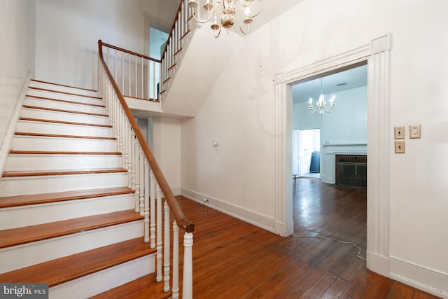 5378 Main St, Stephens City, VA 22655 - staircase featuring a chandelier and hardwood / wood-style flooring