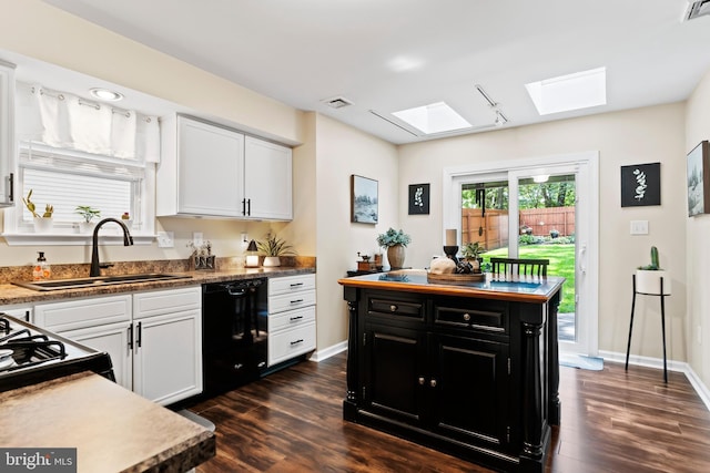 6111 Summit Pointe Dr, Harrisburg, PA 17111 - kitchen with black dishwasher, a skylight, dark cabinets, and dark wood-type flooring